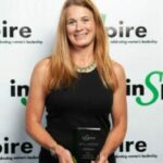 Betsy Anderson holding the Inspire Women Award for Excellence in Healthcare.
